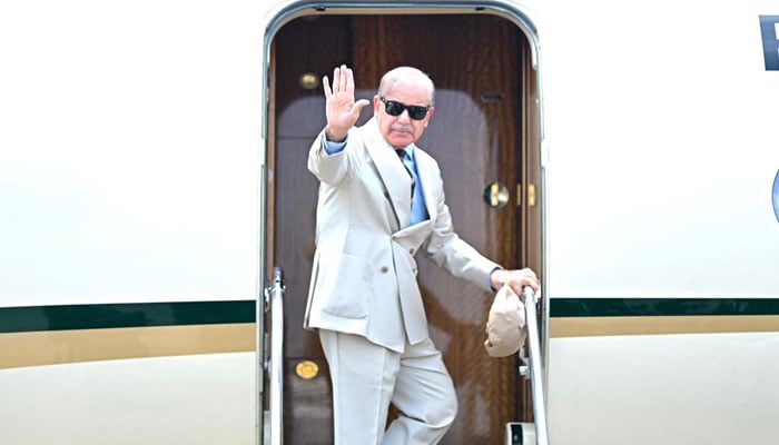 Prime Minister Shehbaz Sharif waves has he boards a plane to Azerbaijan to attend 17th ECO Summit in Azerbaijan on July 3, 2025. — PID