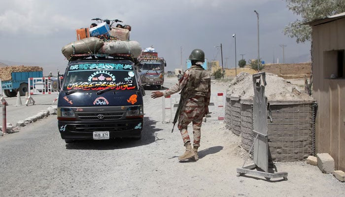 A paramilitary soldier stops and checks passenger vehicles at a security check post, a day after militants conducted deadly attacks, on the outskirts of Quetta, August 27, 2024. — Reuters