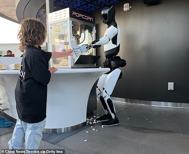 Scientists have revealed the 40 jobs most likely to be replaced by AI. These include interpreters and translators, hosts and hostesses, and customer service representatives. Picture: Tesla's Optimus robot serves popcorn at the Tesla Diner event in California