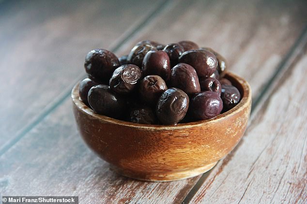Green olives are picked before fully ripened, whereas black olives have been left to ripen fully. But olives may have been packed with a compound to make them appear darker (file photo)