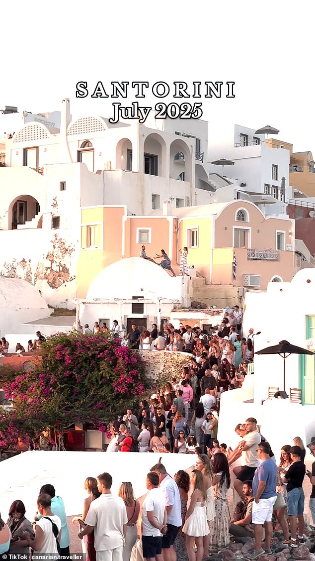Videos have shown the shocking reality of visiting one of the world's most idealised holiday destinations - with an 'overflow' of tourists piling together to catch a glimpse of the evening sun on the once-idyllic Greek isle of Santorini (pictured)