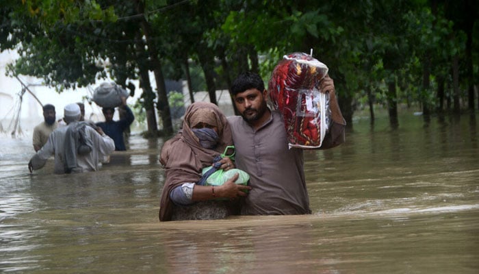 A couple seeks safety in flood-hit Peshawar — AFP