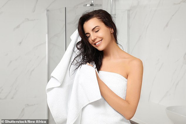 Some people wash their bath towels only once a year, but a microbiologist says we should do it after two uses at the very most (file photo)