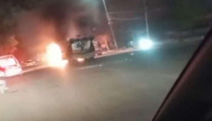 The image shows a dumper truck on fire on Rashid Minhas Road in Karachi on August 10, 2025. — YouTube/Geo News/Screengrab