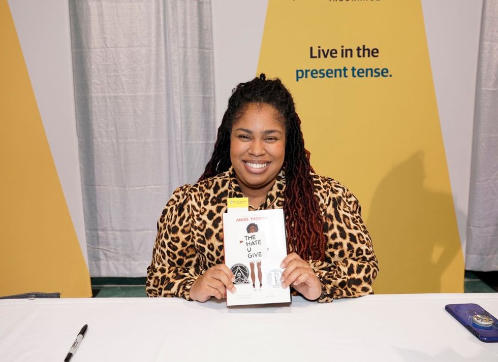 \u200b\u200bAngie Thomas with her book, "The Hate U Give"