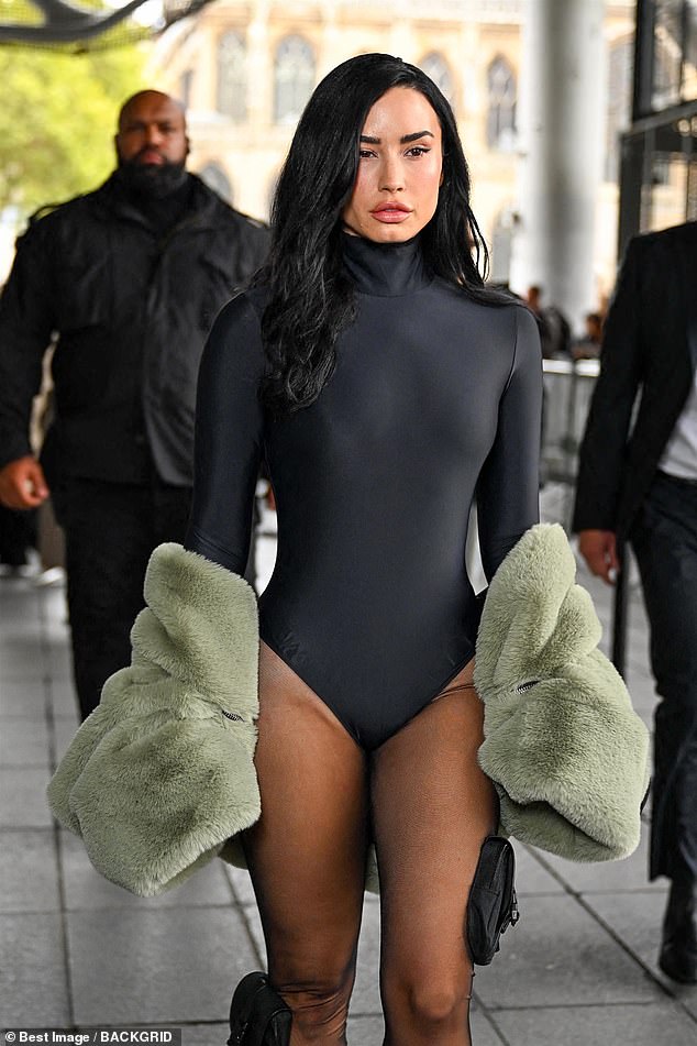 Stepping out in the French capital, the singer, 33, wore a skin tight bodysuit with a highneck and long sleeves