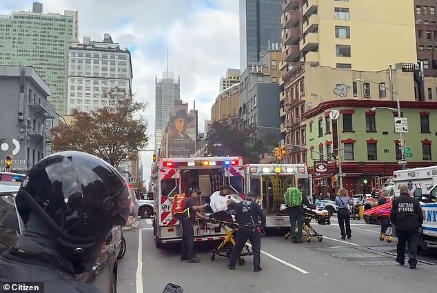 A person is seen being taken onto an ambulance in a stretcher