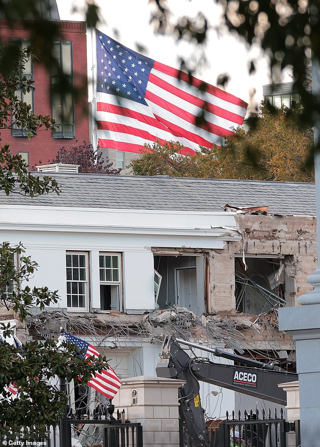 President Donald Trump's large American flag can be seen in the background as workers tear down the White House's East Wing on Monday to make room for the $250 million White House ballroom project