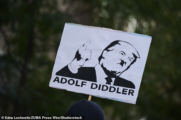 A placard showing the President as Hitler is held by a protester in New York on Saturday