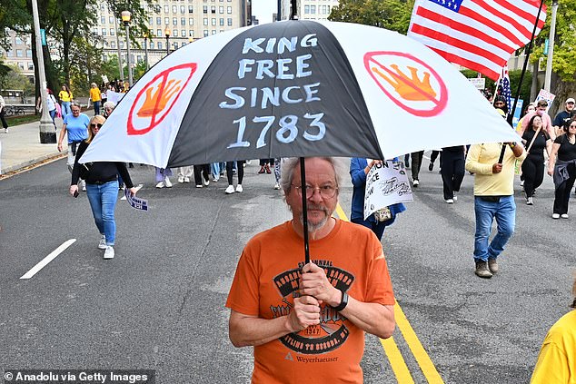 A white-haired liberal man demonstrates against Trump in Chicago on Saturday