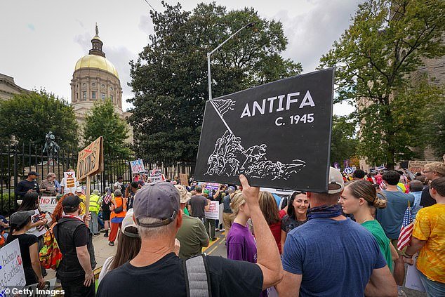 Protesters in Atlanta on Saturday. An old, white man holds an Antifa sign