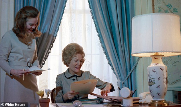 East Wing Staff Director and Press Secretary Constance Cornell Stuart assisting First Lady Pat Nixon at her desk on the Second Floor of the White House on December 30, 1970