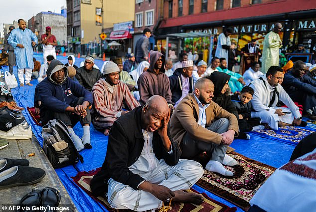 Islam continues to grow in the US and around the world (Pictured: Outside the Masjid At Taqwa Miosque during Eid al-Fitr celebrations in the Brooklyn)