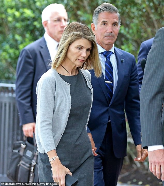 Separate insiders have given insight into their shock split after 28 years of marriage -with some claiming their public legal woes had driven a wedge between them; the pair seen outside of courthouse in Boston in 2019