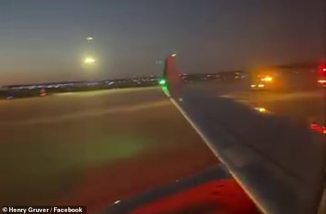 Police cars arrive at Eppley Airfield in Omaha after the flight made an emergency landing