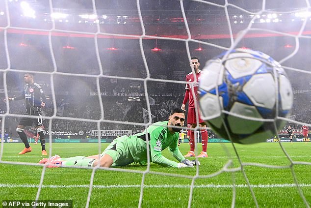 Liverpool goalkeeper Giorgi Mamardashvili watches on as he concedes the opener to Frankfurt