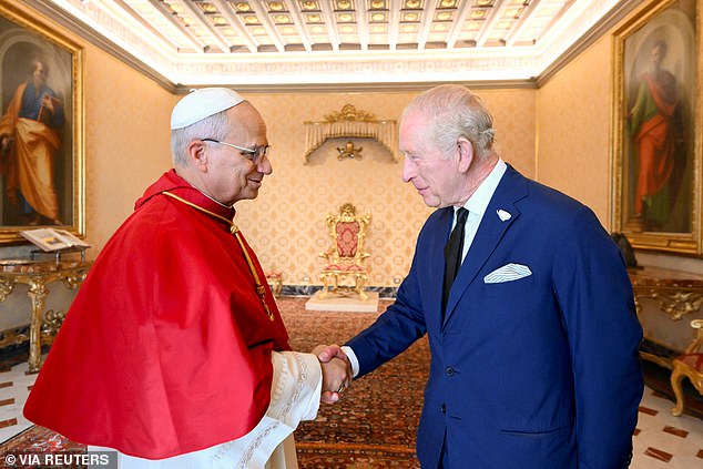 Pope Leo XIV greets King Charles III during a private audience at the Vatican this morning