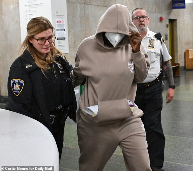 Diawara covered her face with a mask and wore a tan sweatsuit emblazoned with the phrase 'Good Vibes Only' as she appeared in court