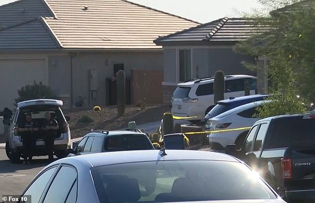 Police outside the house in Marana, north of Tucson, Arizona, as they investigated the scene. Parker was left in the blue Honda Acura SUV behind the police tape