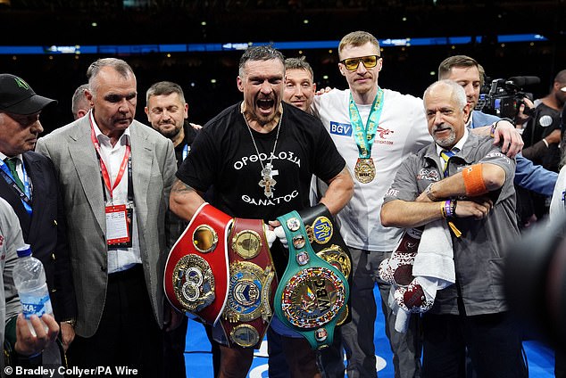 Usyk pictured celebrating holding the IBF, IBO, WBC and WBO belts after beating Dubois in their heavyweight rematch at Wembley Stadium on July 19