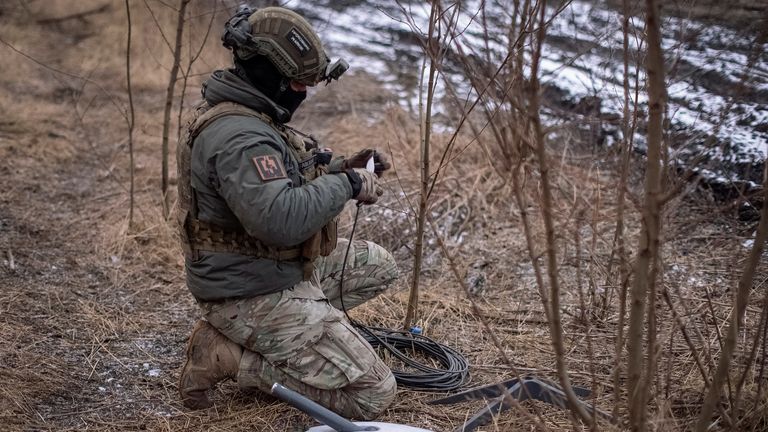 A Ukrainian serviceman prepares a Starlink satellite in Ukraine. Pic: Reuters