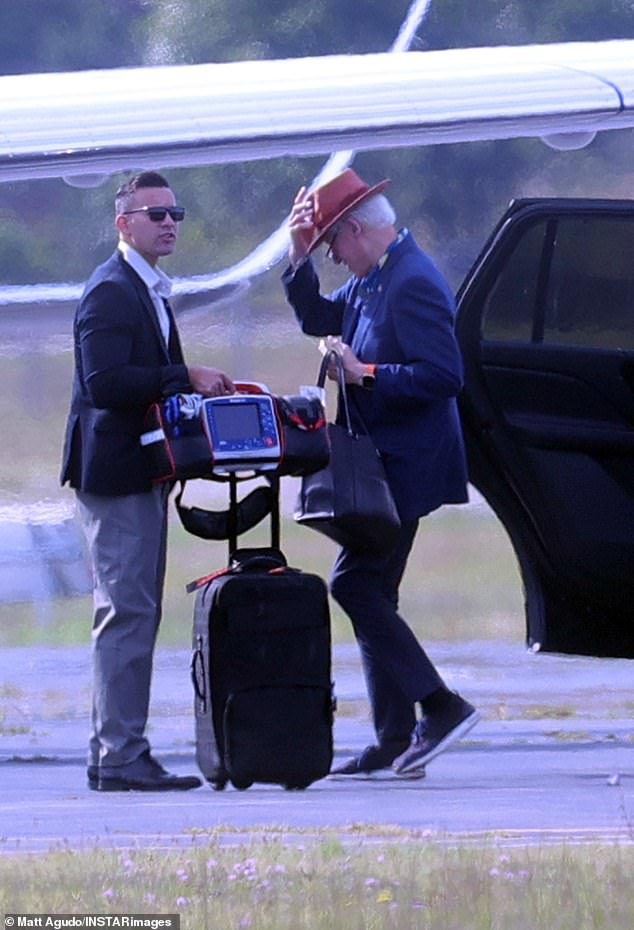 Clinton is seen here in August leaving the Hamptons with a portable defibrillator