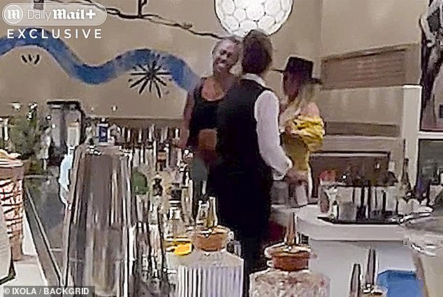 Onlookers described how Spears' top slipped off her shoulders as she knocked over glasses and dropped items across the restaurant floor