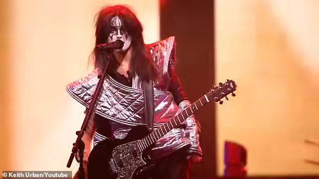 While Urban was performing his hit song, Kiss A Girl, Swift and her band crashed the stage wearing full KISS makeup and costumes
