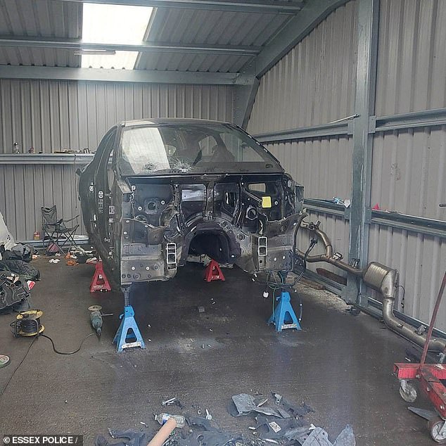 A BMW car being stripped down for spares in an illegal chop shop identified by Essex Police earlier this year