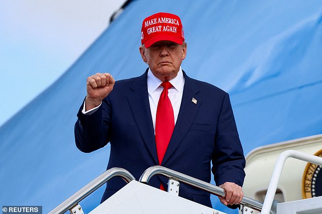 Trump gestures as he disembarks Air Force One, following his Asia trip, at Joint Base Andrews, Maryland, on Thursday