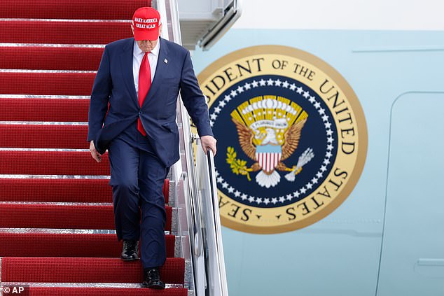 Trump walks down the stairs of Air Force One as he returns from Asia on Thursday