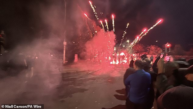 Protesters throw fireworks at Gardai officers near the Citywest Hotel in Saggart on October 2022