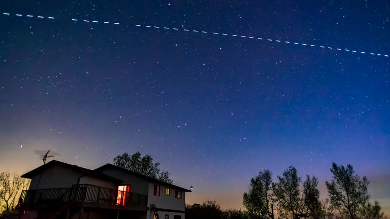 Starlink satellites pass above a house in California. File pic: Alan Dyer/AP
