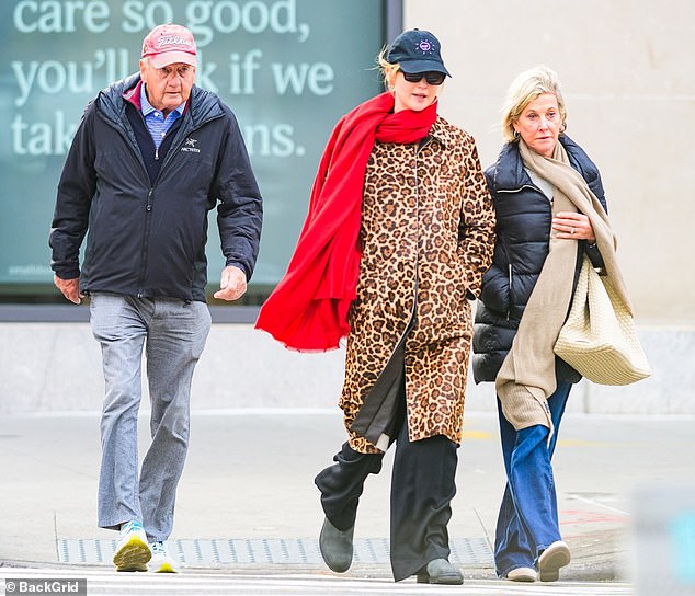 Jennifer Lawrence bundled up to take an autumn stroll with her parents Gary and Karen Lawrence in Manhattan on Thursday not far from her $21.9M West Village townhouse