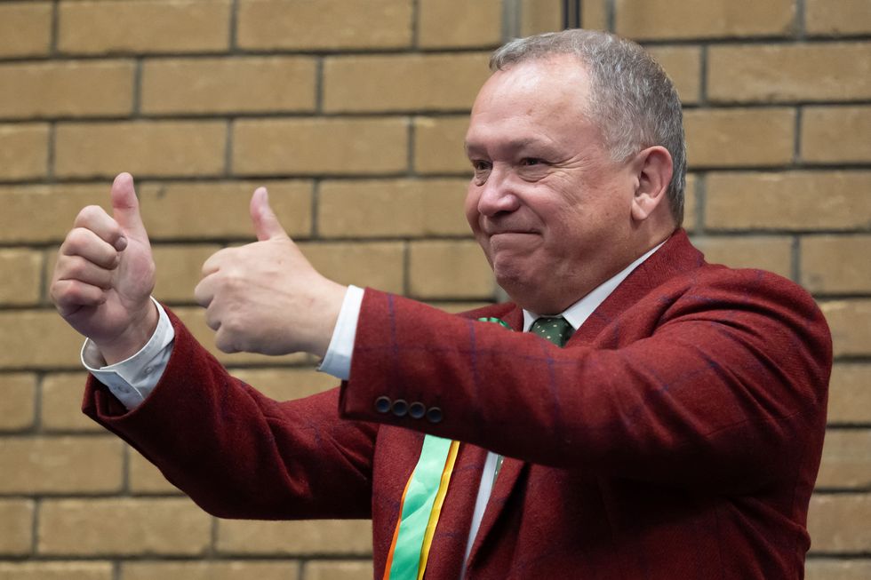 Plaid's Lindsay Whittle celebrates winning his Caerphilly seat on Friday morning