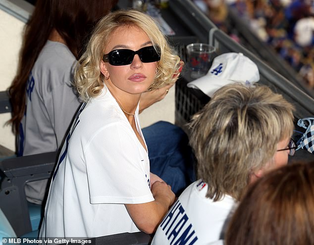 The actress styled her platinum blonde bob in Marilyn Monroe-inspired curls and repped the baseball team in a jersey paired with cowboy boots