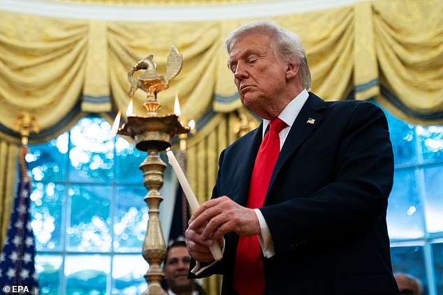 Donald Trump lights a diya candle during a Diwali celebration in the Oval Office of the White House on Tuesday