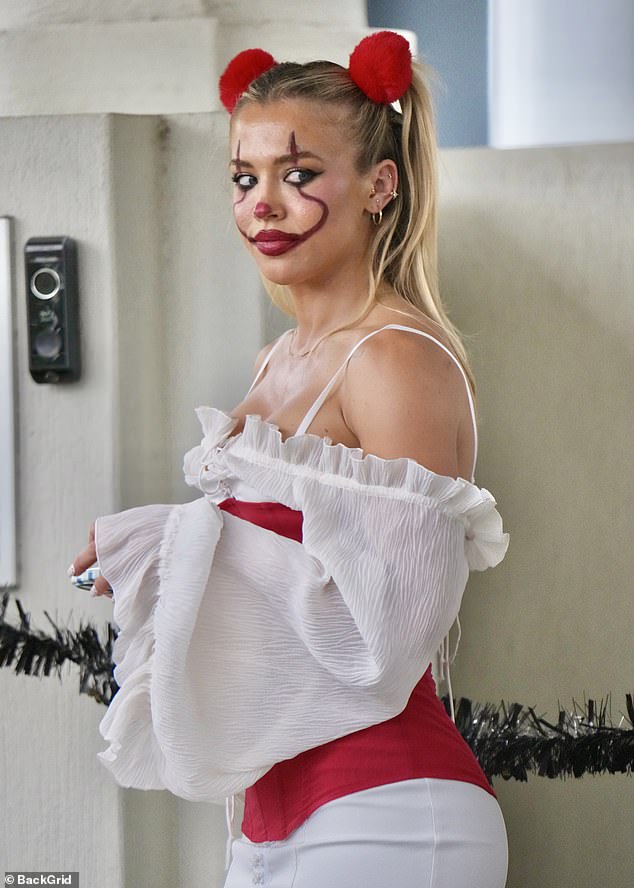 The mum-of-three finished off the Pennywise-inspired outfit with red face paint, fluffy red pom-pom baubles and a creepy baby doll