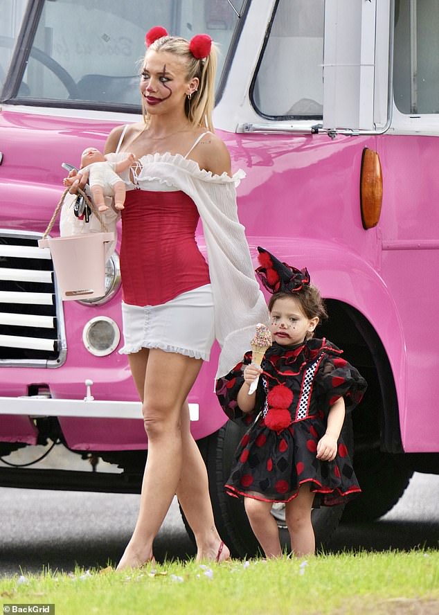 Her children matched her in scary clown attire, with her youngest donning polka dot dress and her eldest wearing a striped shirt and pants combo