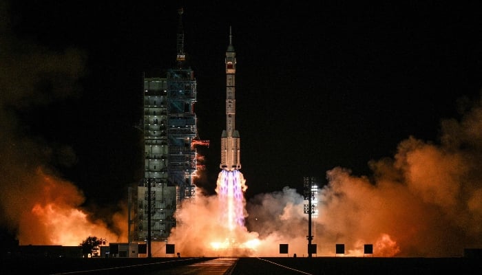 A Long March-2F carrier rocket, carrying the Shenzhou-21 spacecraft and a crew of three astronauts, lifts off from the Jiuquan Satellite Launch Centre in the Gobi desert, in northwest China, on October 31, 2025. — AFP