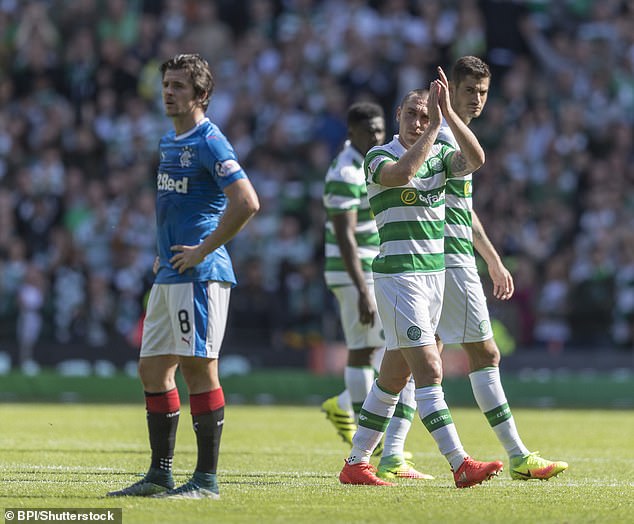 Barton looks on in despair as Brown applauds the home support