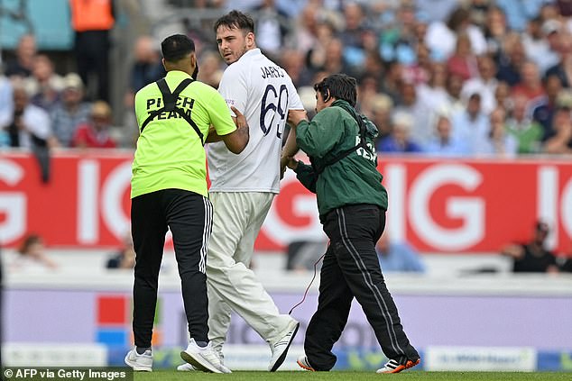 Jarvo is escorted from the field after he delays play on the second day of the fourth cricket Test match between England and India in 2021