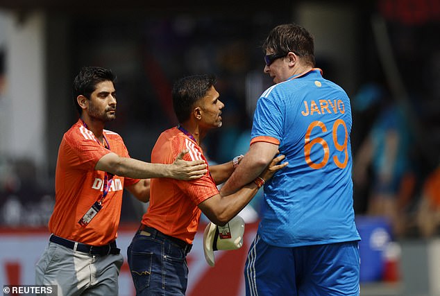 Ground staff remove Jarvo from the field during the ICC Cricket World Cup in Chennai, India