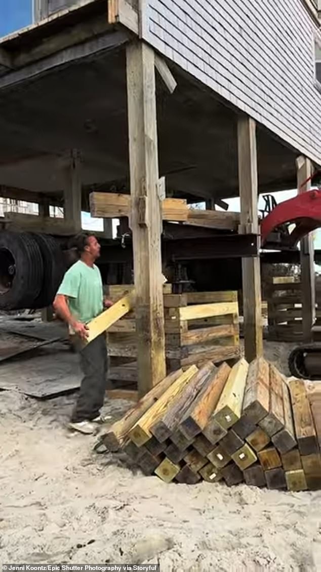 Crum Works construction workers moving a home 60 feet back from the ocean in Buxton, NC, where homes have been falling into the Atlantic