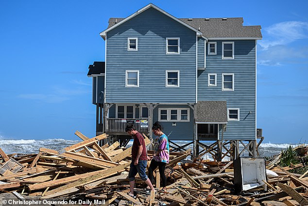 Buxton residents inspect the debris the fallen homes have left. Owners have to pay for their own debris cleanup and many don't leaving to Barry Crum to come in and do it