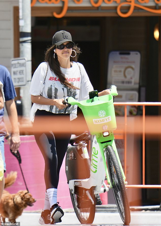 The 44-year-old blended in with locals as she cycled through the streets on an e-bike