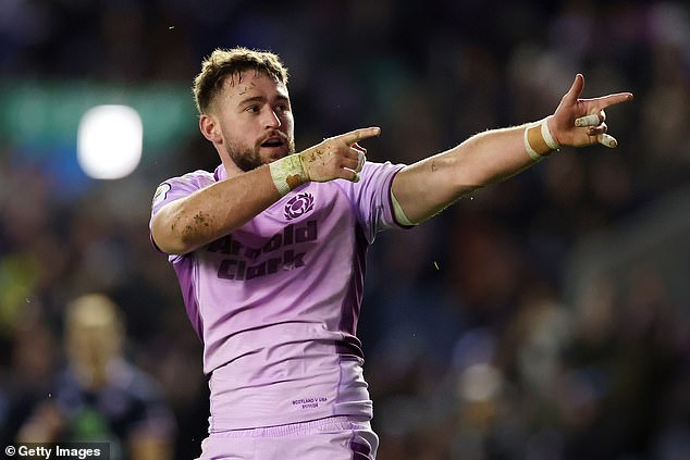 Ollie Smith of Scotland celebrates after scoring his team's thirteenth try