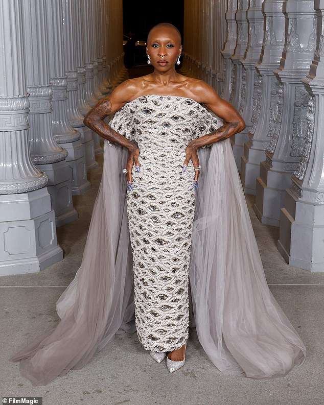 Wicked star Cynthia Erivo flashed her ripped, tattooed arms in her white off-the-shoulder dress, which was decorated with intriguing eye designs of varying sizes