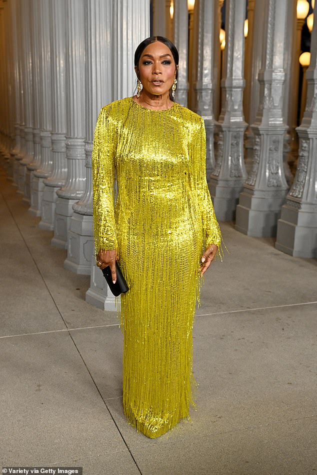 She wore her dark hair pulled back and parted down the middle, and she accessorized with a slim black clutch