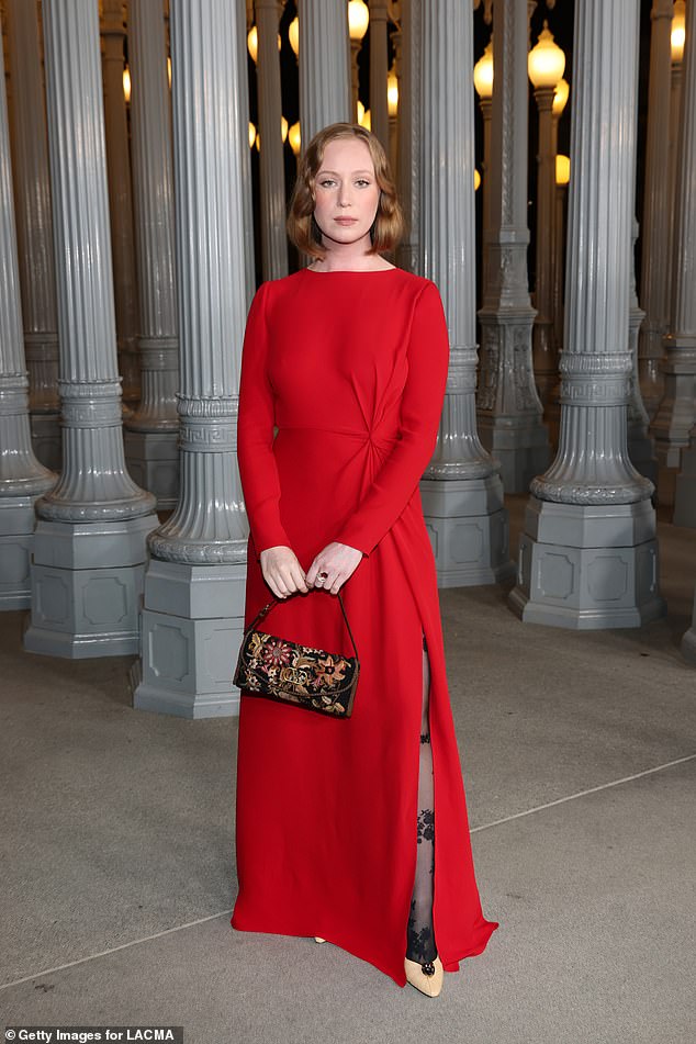 Hacks star Hannah Einbinder also favored red with a long gown with a high slit. She carried a slim floral-print handbag and wore her red hair in a delicately textured bob